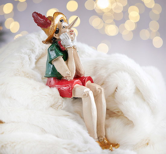 Pinocchio juldekoration sittande